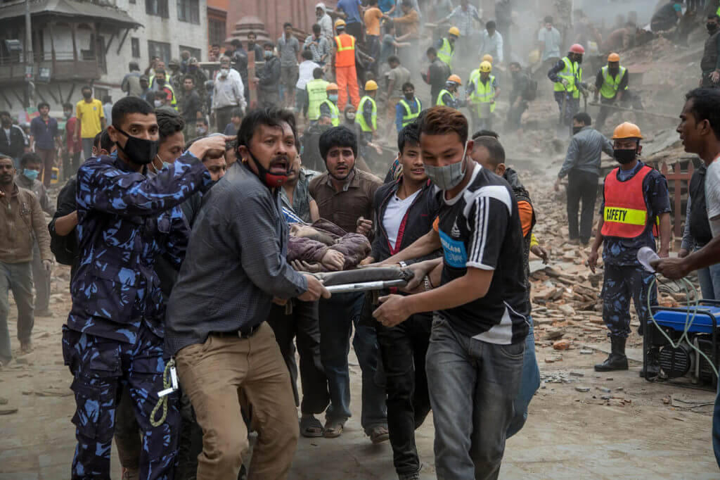 Rescuers help victims of an earthquake in Kathmandu, Nepal