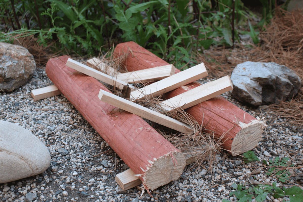 A fire lay called long fire, made up of two logs with smaller sticks in between them that are set on fire