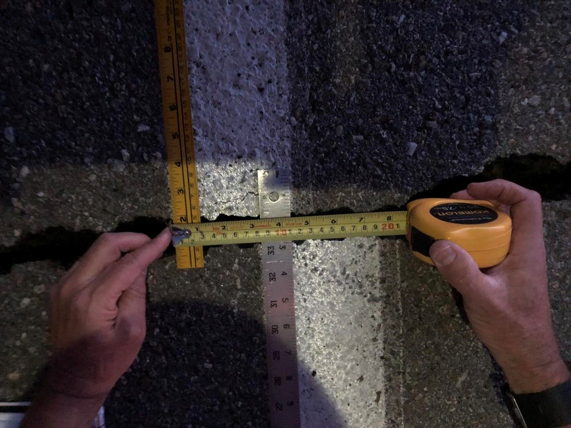 USGS measure the crack left by the July 5 California quake on the road