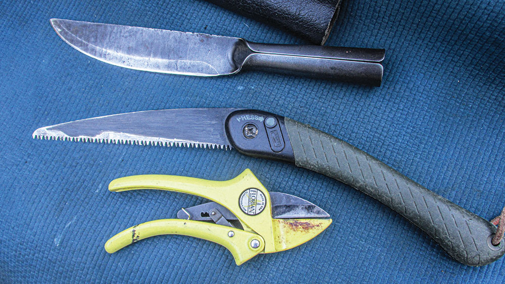 The Cold Steel Bushman (top), a folding saw and Florian ratchet-cut clippers.
