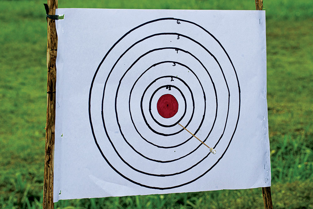 blowgun practitioners shoot at targets to improve their skills