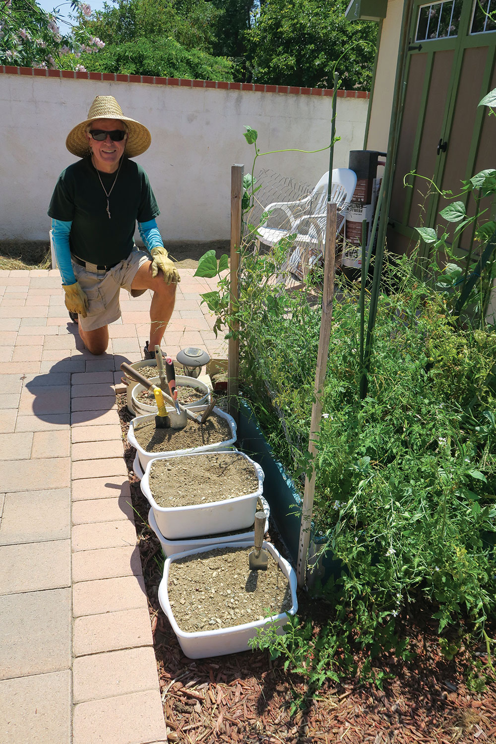 Hyke shows the soil he’s dug from a newly prepared plot. 