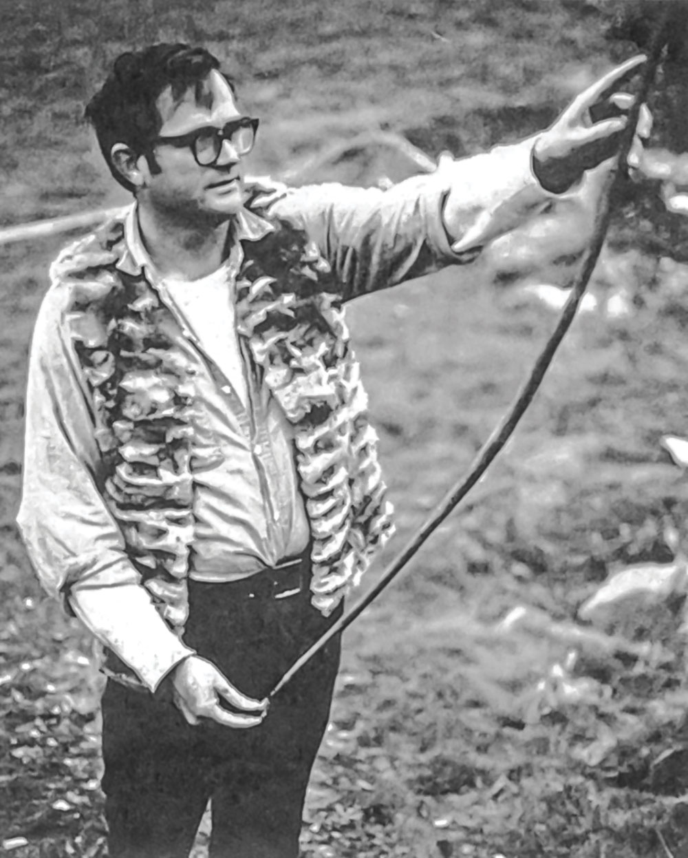 Olsen does a final check of his field bow, which was made under primitive conditions. (Photo: courtesy of Olsen’s publisher, Chicago Review Press)