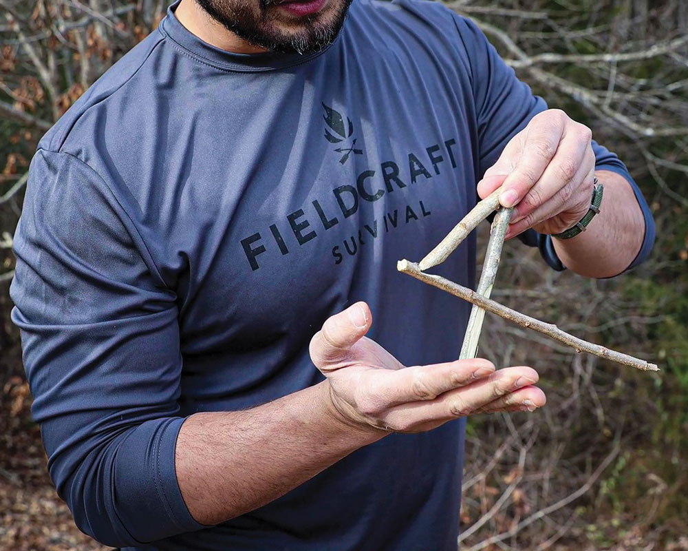 A figure-four trap is taught in a Fieldcraft Survival class during the “predator mindset” portion of the Wilderness Survival Level 2 course.