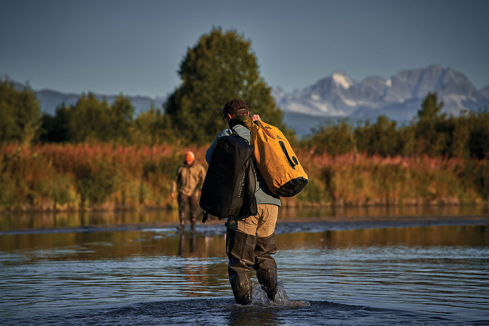 Members of the Fieldcraft Survival team use their Fieldcraft Survival 40L duffel bags while fishing in Alaska.