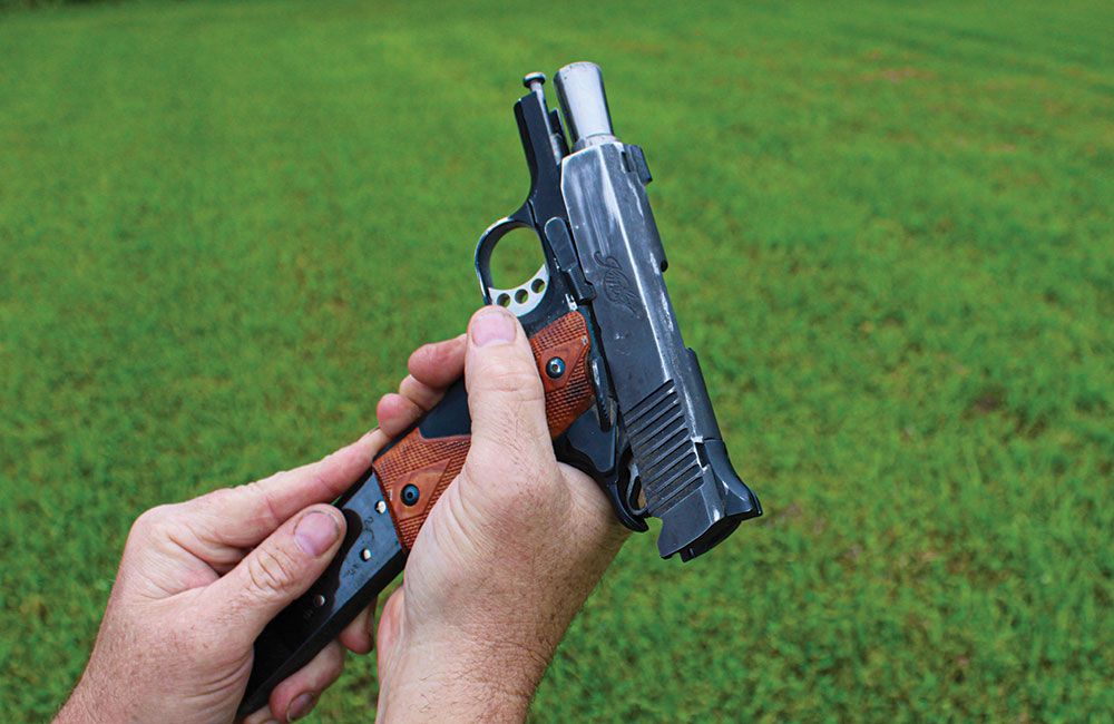 As the magazine drops, grab the spare magazine, indexing the first finger along the front of the mag, and insert it into the mag well.