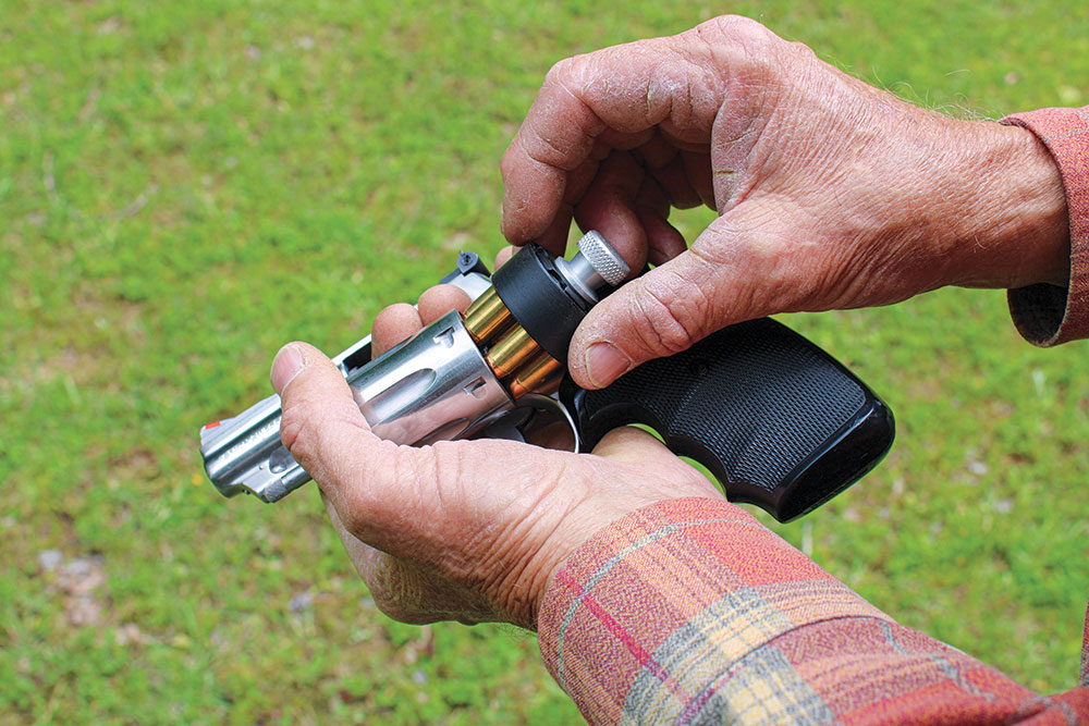 Once the cylinder is empty, use the speed loader to insert fresh rounds and let the reloader drop.