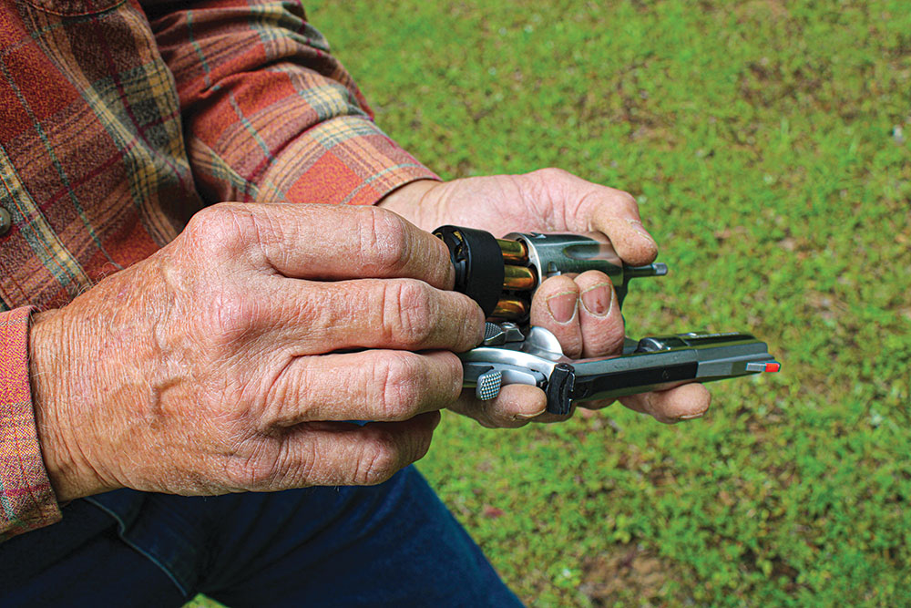 Once the cylinder is empty, use the speed loader to insert fresh rounds and let the reloader drop.