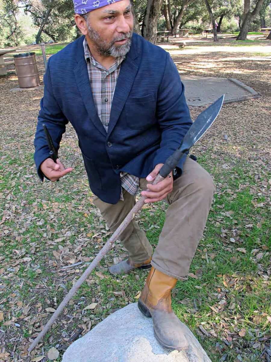 Wilderness survival skills expert Angelo Cervera shows the Bushman on a pole for hunting or as a spear.