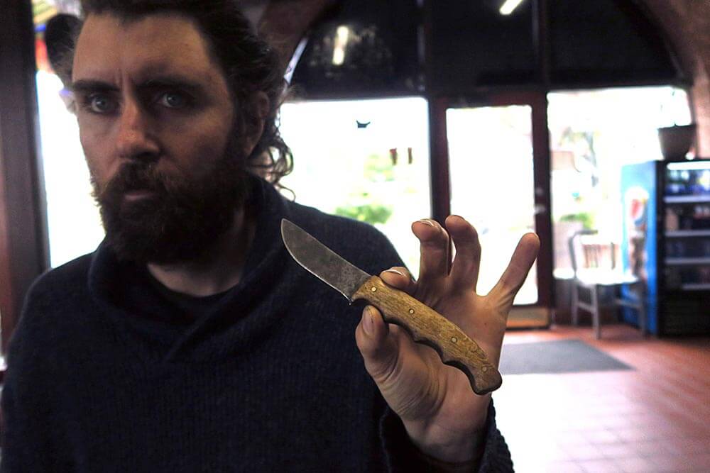 Herbalist Cash Robertson shows the Elijah Williams custom sheath knife.