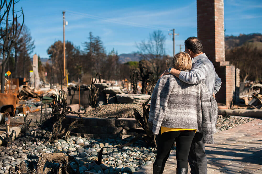 A couple looking at destroyed property