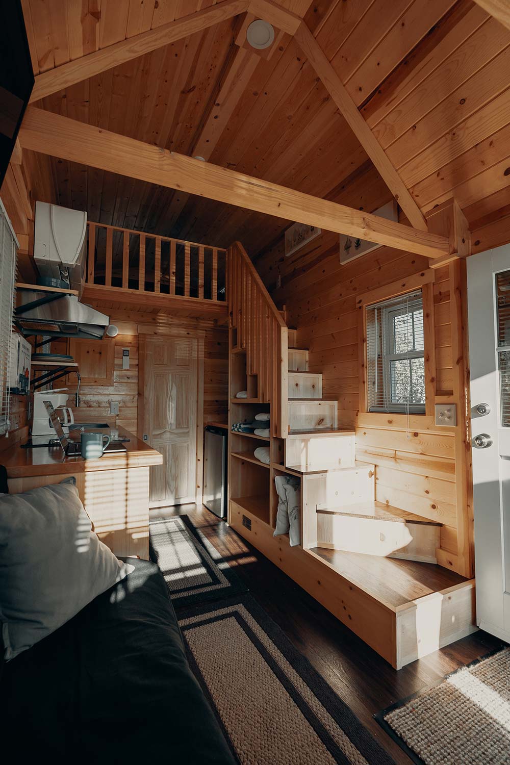 In this tiny house, the stairs do double duty as storage. 