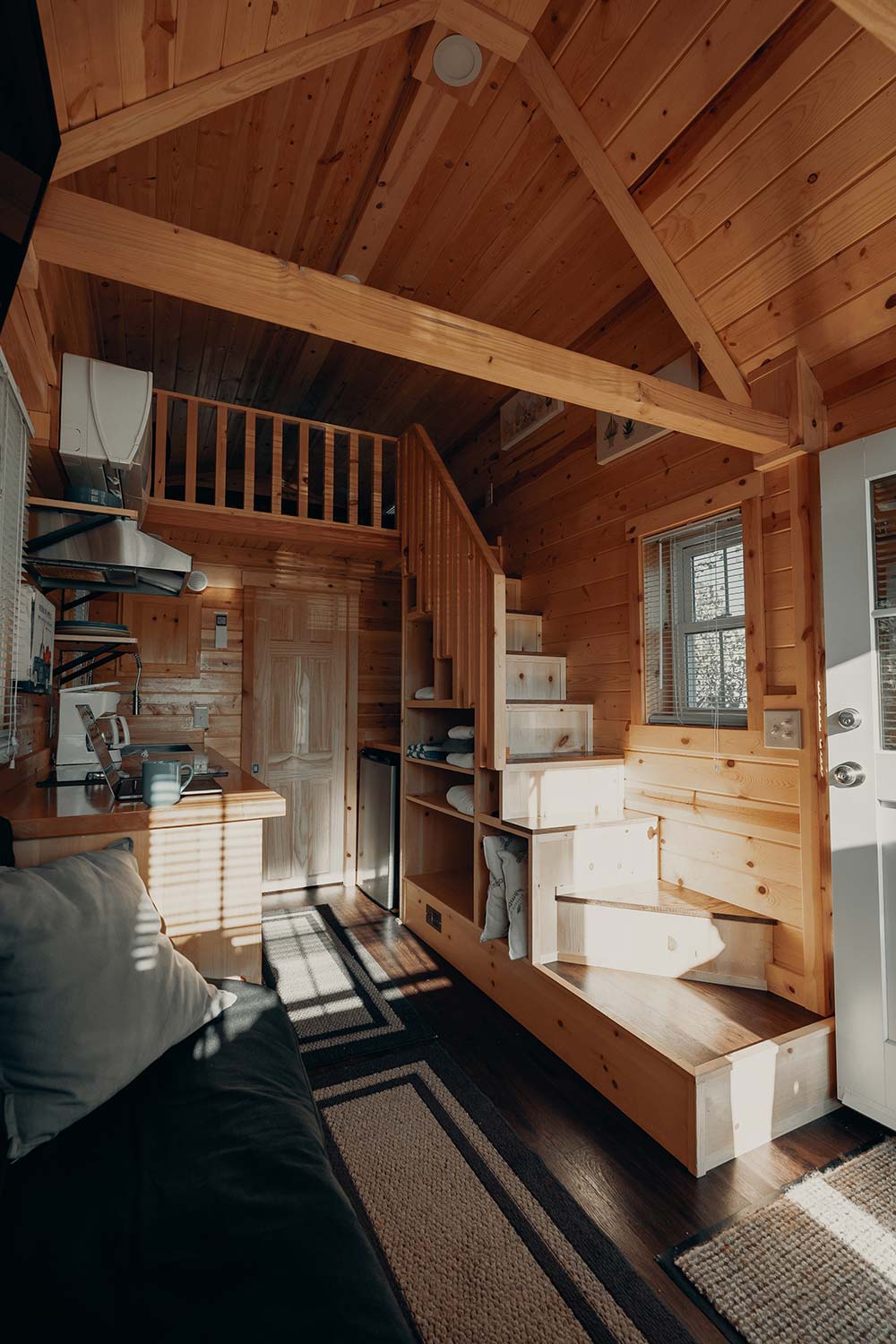 In this tiny house, the stairs do double duty as storage.