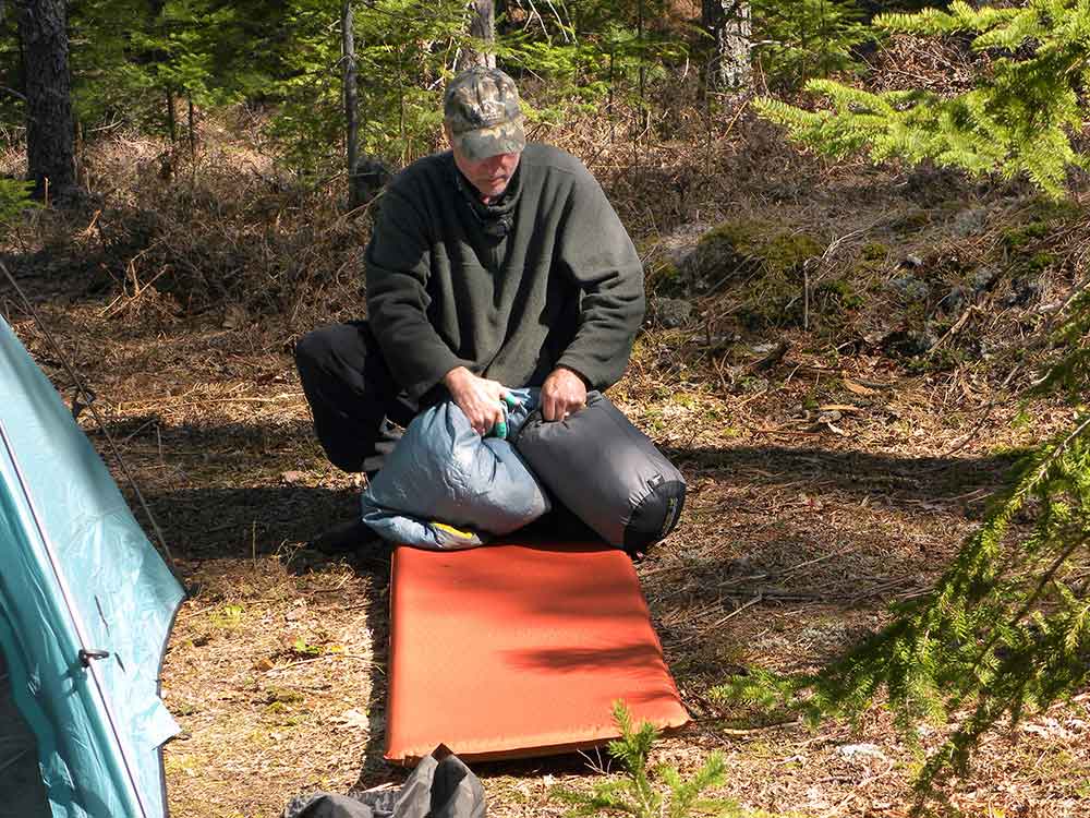 checking bedroll for hidden snake